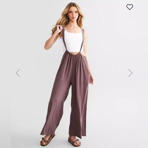 New in package: Mauve Wide Suspender Overalls. Can fit up to a large size.